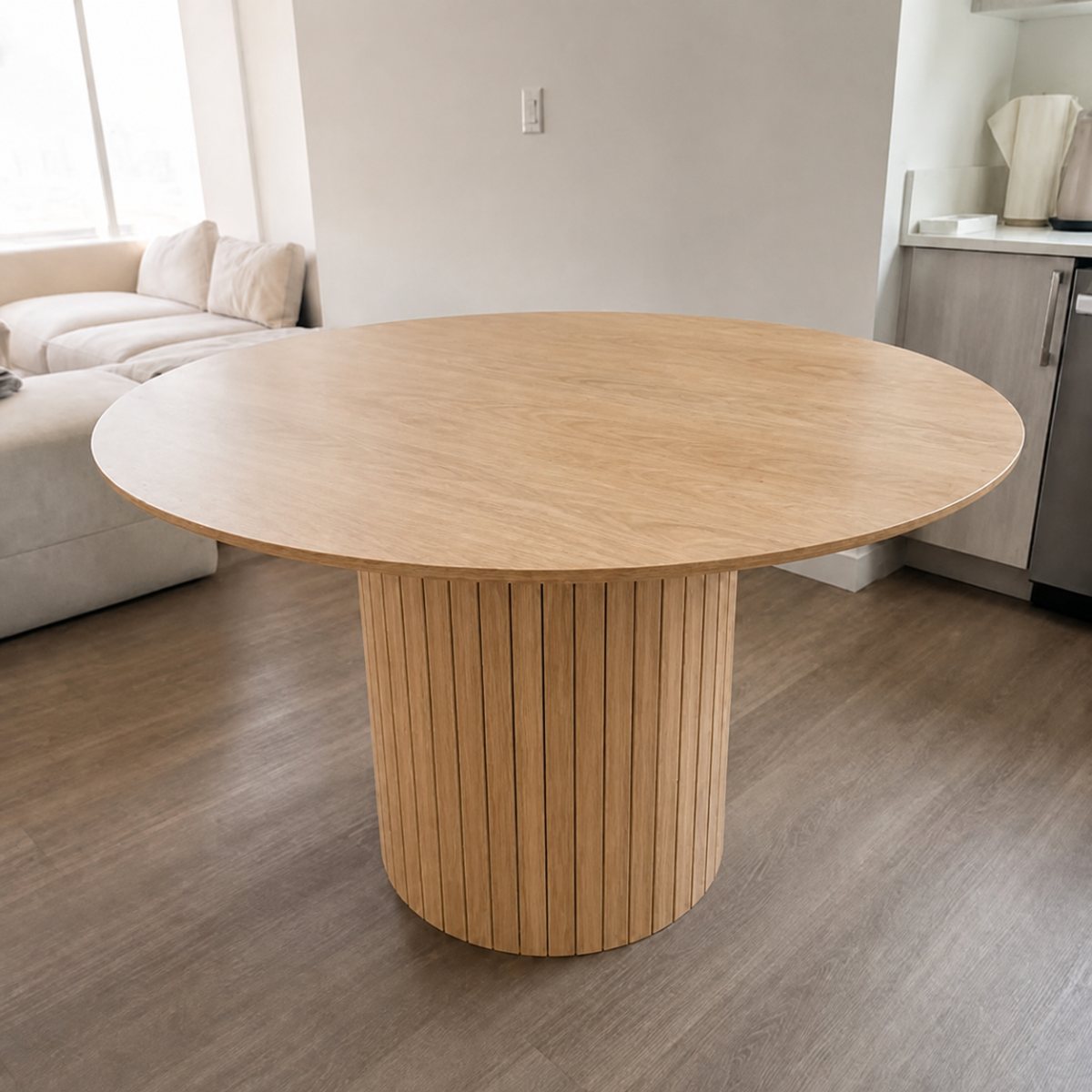 Aria Round 47-inch round dining table with fluted pedestal in a dining room