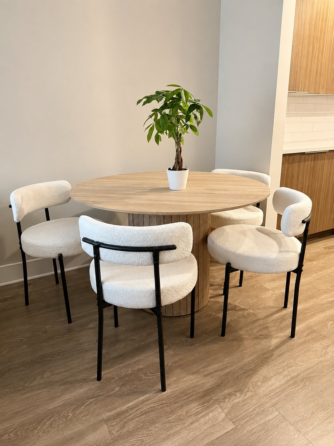 Cove Round dining set with 4 black frame chairs in a dining room