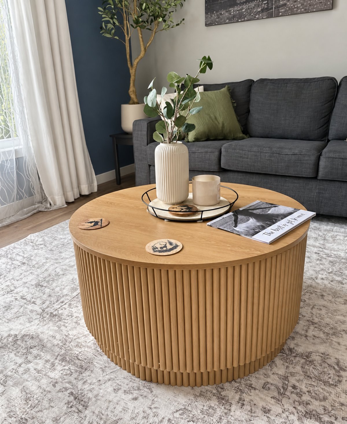 Juno Coffee Table — oak finish, round fluted base, styled in a living room
