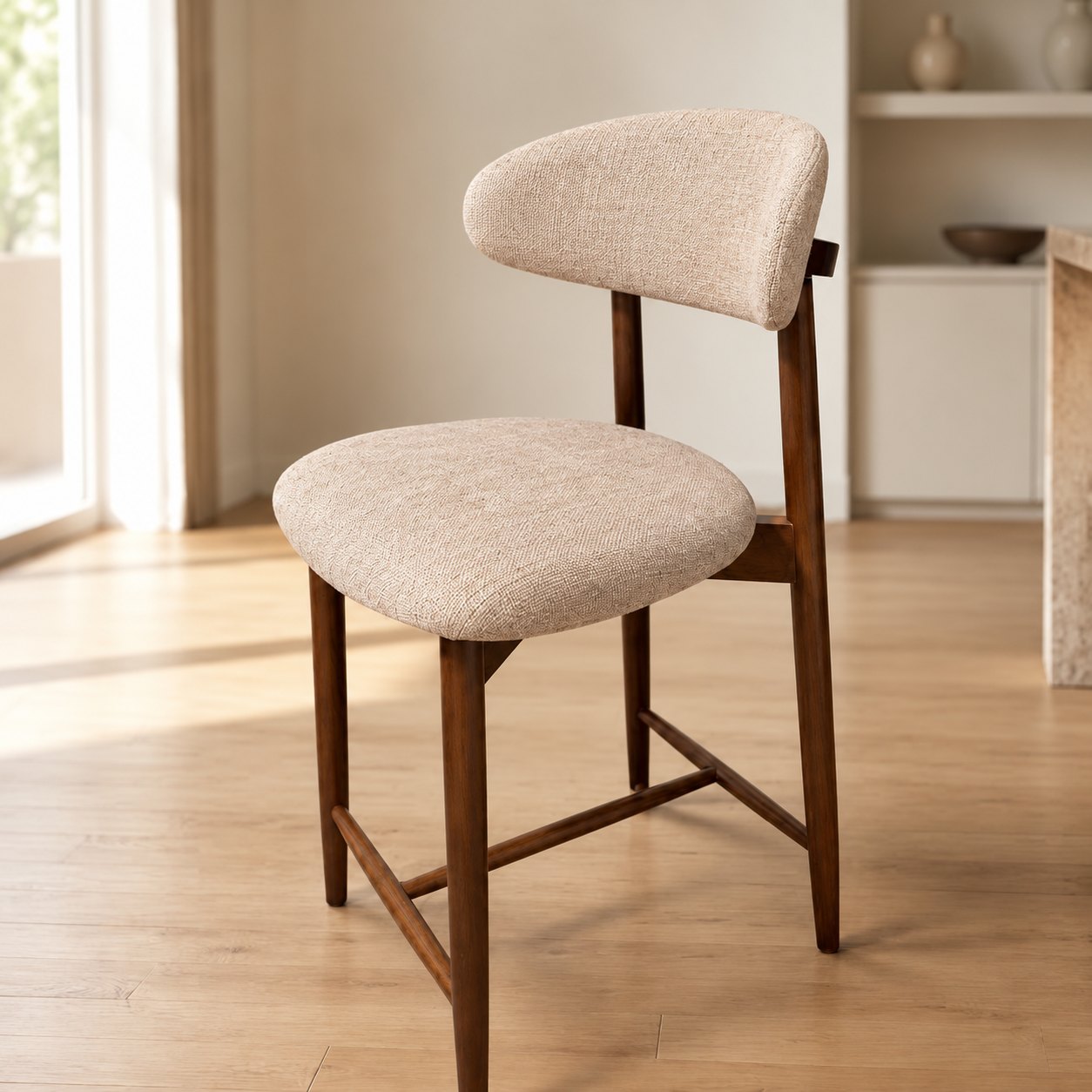 Rhea Barstool — single counter stool in dark walnut with cream bouclé seat and curved back, styled in a sunlit room